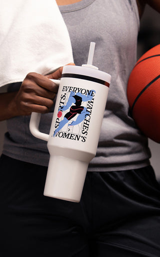 Stanley 1913 white tumbler with straw and handle featuring "Everyone Watches Women's Sports" basketball graphic, held by person.