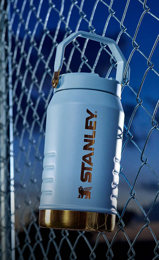 Lionel Messi Stanley 64 OZ Water Jug Hanging From Chain link fence