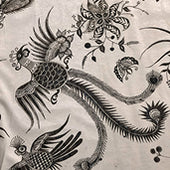 Black and white intricate illustration of a mythical phoenix or dragon bird with ornate floral details on fabric